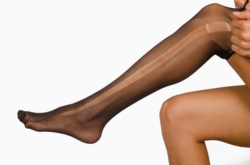 DFP67C Take of a torn pantyhose on female legs