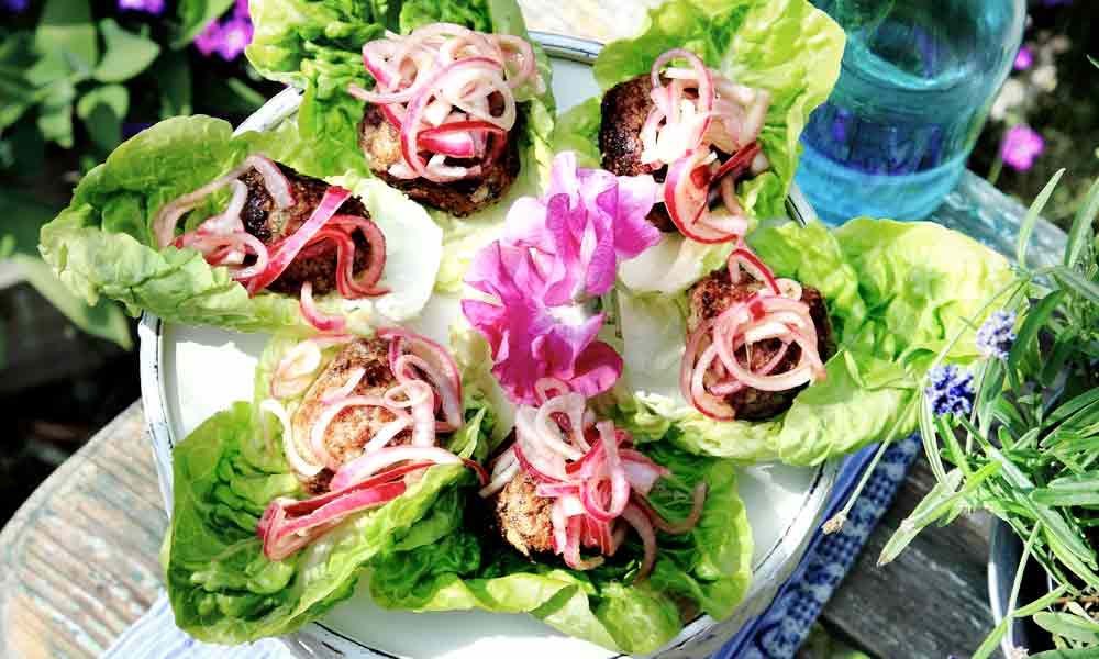 Lammfärsbullar i sallad med picklad lök.