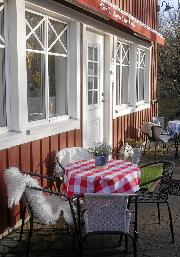 Kaféets framsida med utemöbler med värmande filtar och fårfällar.